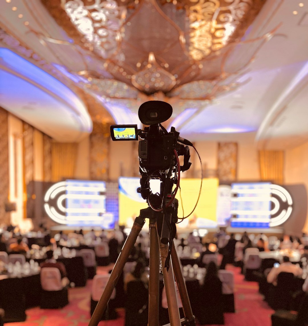 Broadcast journalist presenting to an audience at a media event